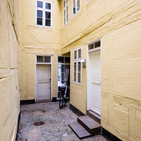 Treat yourself to a stay in an old Danish building with a mellow yellow exterior
