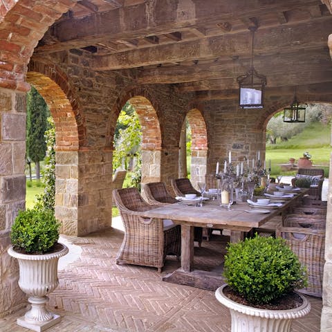 Convene for an alfresco dinner underneath the stone loggia