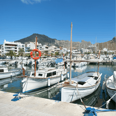 Soak up the sunshine and swim in the sea in Port de Pollença, a short drive or fifteen-minute walk away 