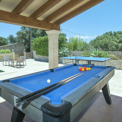 Play a game of pool or table tennis on the outdoor tables