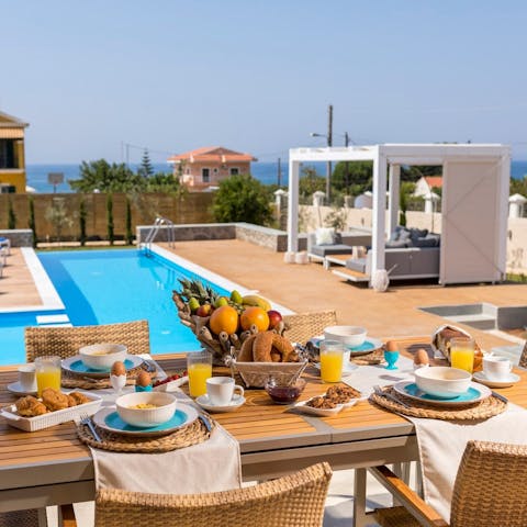 Gather around the dining table for a hearty breakfast, looking out at the Ionian Sea