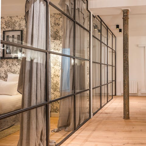 Admire striking features of the home, such as the glass partition wall