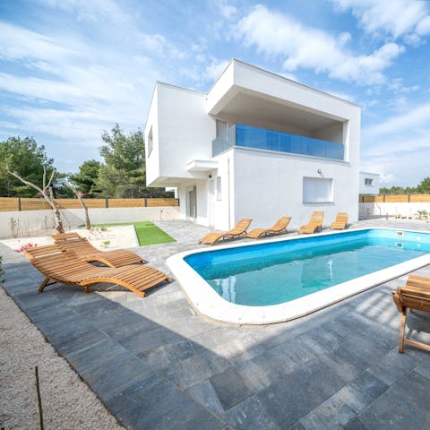 Relax on the sun-drenched patio and take a refreshing dip in the pool