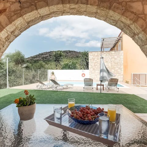 Tuck into breakfast in the shade of the beautiful stone archway