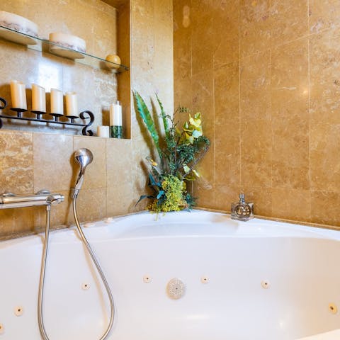 Relax and unwind in the main suite's luxurious hydromassage bathtub