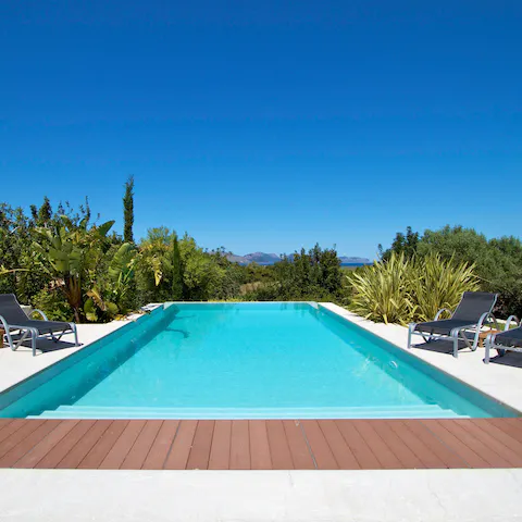 Jump into the home's peaceful swimming pool surrounded by palms
