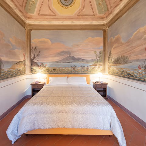 Fall asleep while gazing at the pretty frescoes that line the bedroom walls