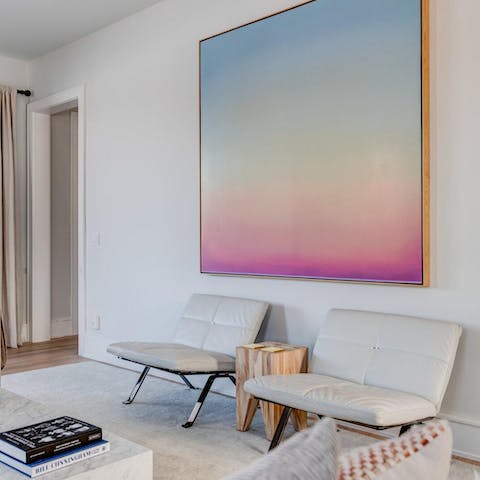 Admire the chic collection of artworks throughout the home