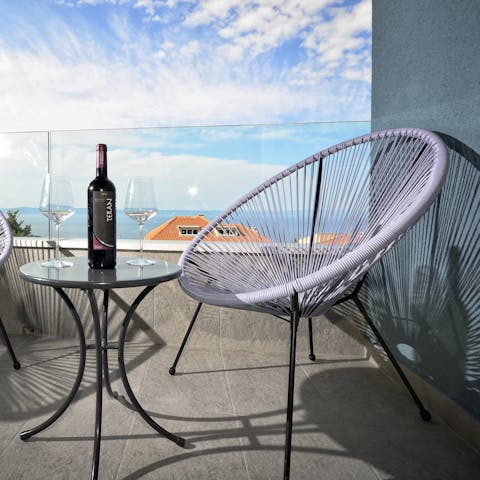 Watch the sunset from your balcony with a glass of wine in hand