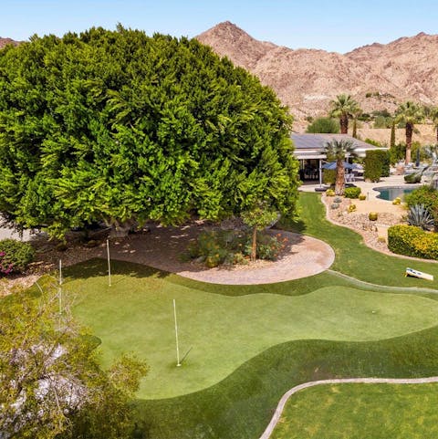 Practice putting on the four-hole golf green