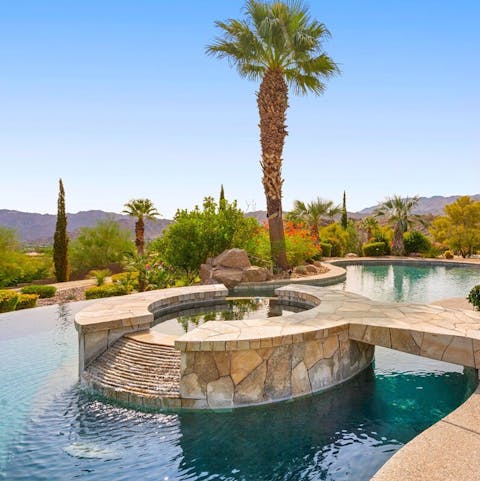 Soak up the views in the waterfall hot tub