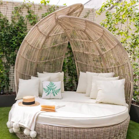 Curl up on the outdoor day bed with a good book and a cool drink