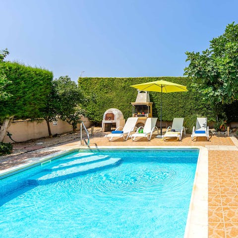 Relax on a sun lounger by the private outdoor pool, before taking a refreshing dip