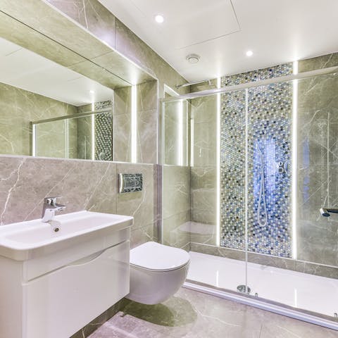 Start mornings with a relaxing soak under the marble-clad bathroom's rainfall shower