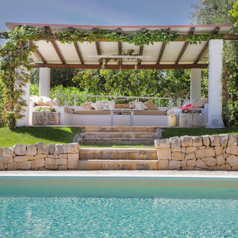 Relax under the vine-covered gazebo overlooking the pool