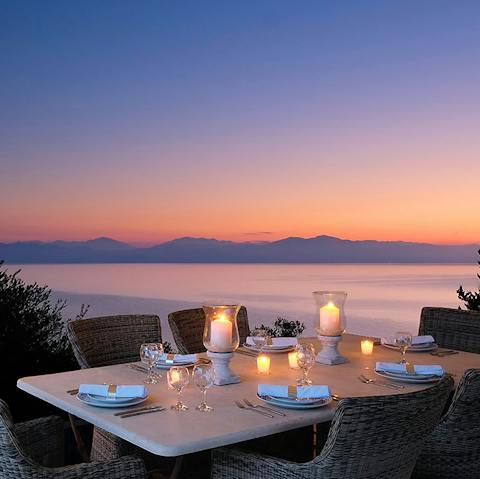 Enjoy a candlelit dinner with views over the Ionian sea as the sun sets