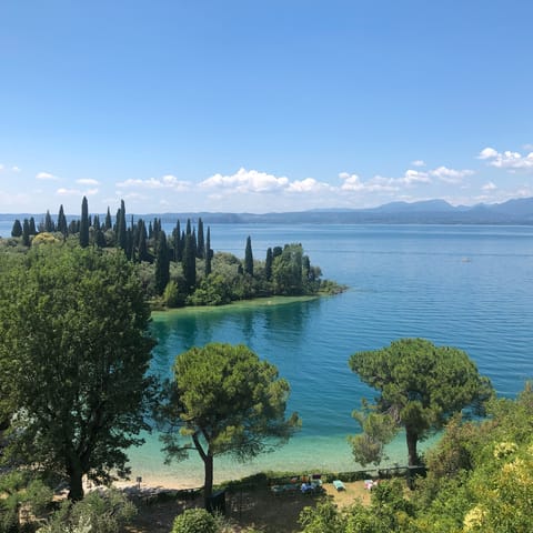 Stroll down to the sandy beaches of Lake Garda and take in the stunning scenery of the calm waters
