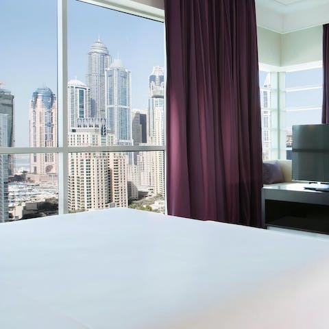 Wake up to towering skyscraper views from the corner windows