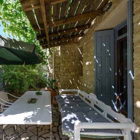 Tuck into loukoumades on the shaded terrace