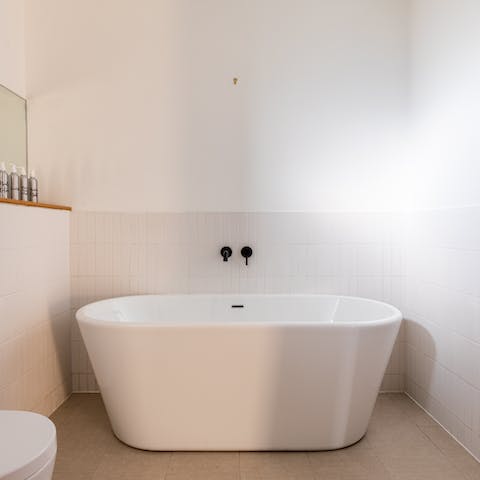 Lie back into bubbles in the home's elegant freestanding bathtub