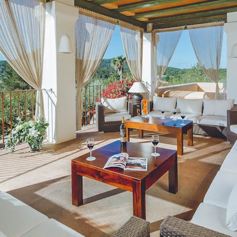 Pour a glass of wine and enjoy the view from the beautiful, covered balcony