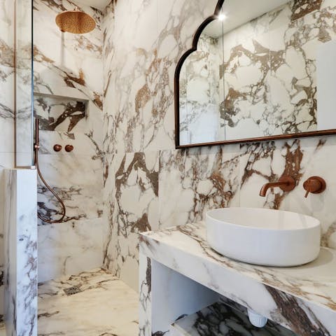 Pamper yourself in the marble-clad bathrooms with their luxurious rainfall showers