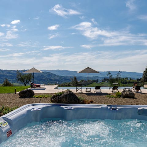 Admire the views over Tuscany from hot tub
