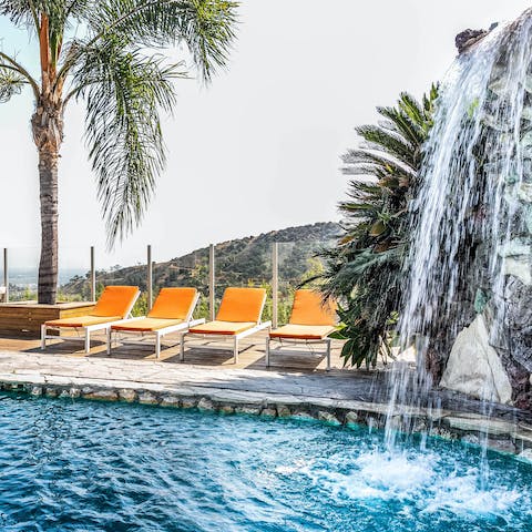 Soak up the sun and soothe aching muscles in the pool waterfall