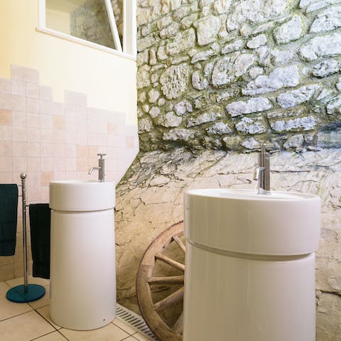 Freshen up in the characterful bathroom with an ancient stone wall