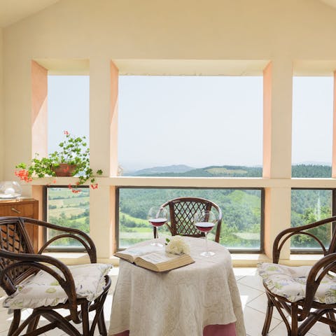 Sip wine with a splendid view of Tuscan rolling hills