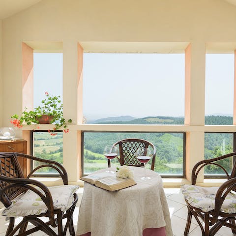 Sip wine with a splendid view of Tuscan rolling hills