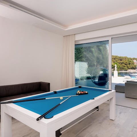 Get competitive with a game or two of pool with a sea breeze blowing in through the glass door