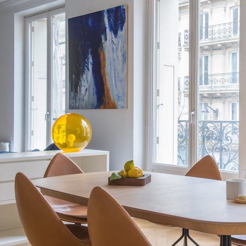 Gather around the dining table with its designer chairs for a celebratory meal at home
