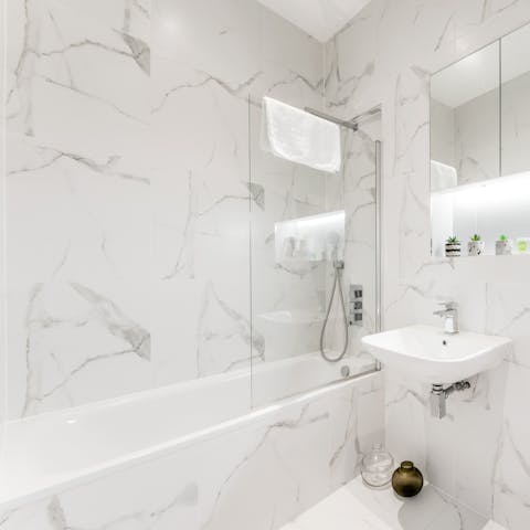 Treat yourself to a long soak in the marble-clad tub 