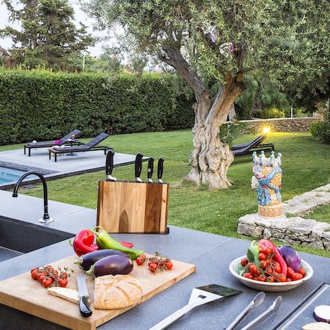 Rustle up delicious meals in the outdoor kitchen, while looking out at the enchanting surroundings