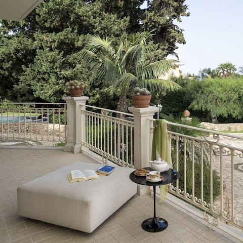 Take a moment alone on the terrace, indulging in your holiday read