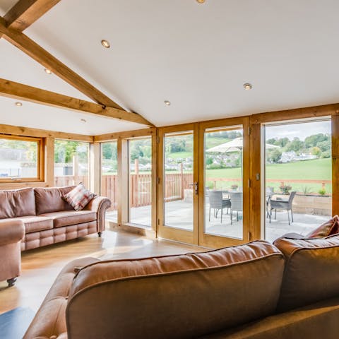 Bask in natural light and rolling views on the leather sofas in the living room