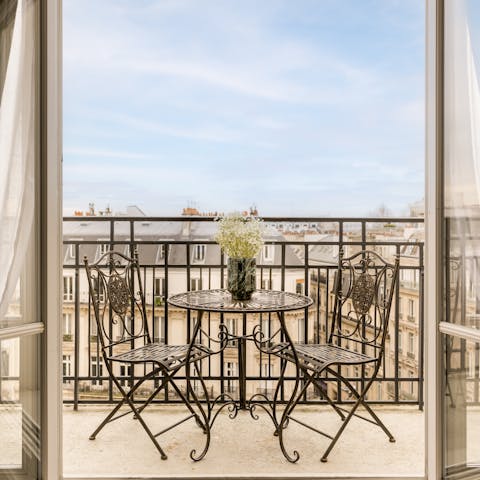 Sip wine on the private balcony with views across Paris