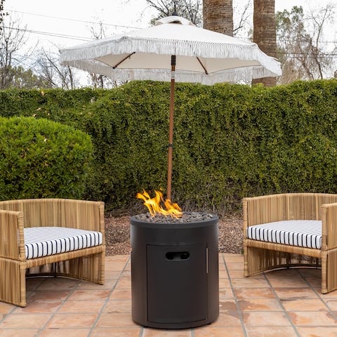 Gather together with drinks around the fire pit