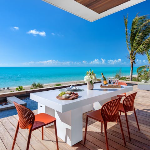 Tuck into delicious Bahamian cuisine while gazing out at ocean views from the alfresco dining area
