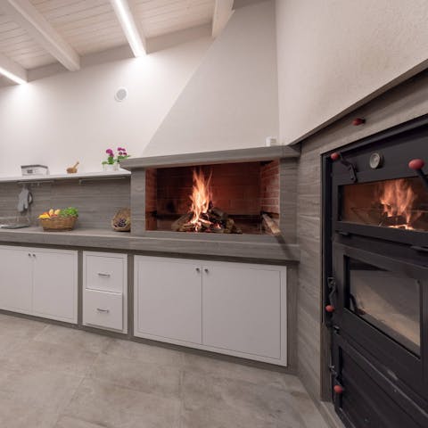 Fire up the pizza oven in the made-for-action, outdoor kitchen