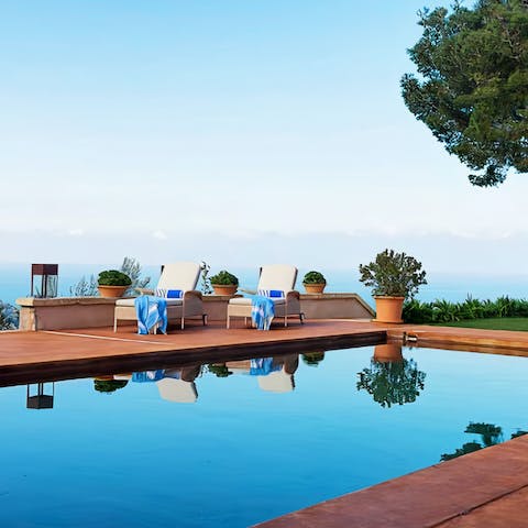 Swim gentle laps in the private swimming pool with the seascape in the background