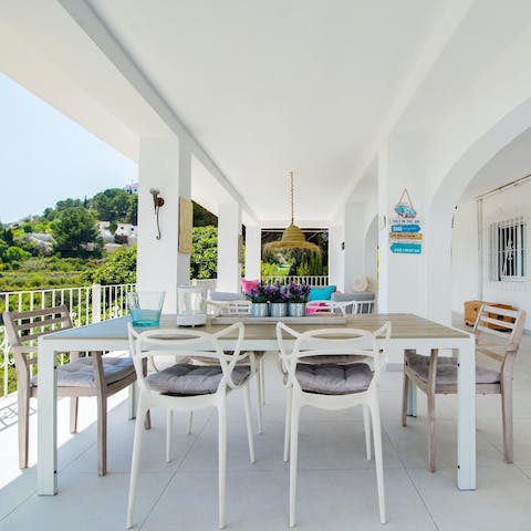 Gather under the covered terrace for cocktails at sunset
