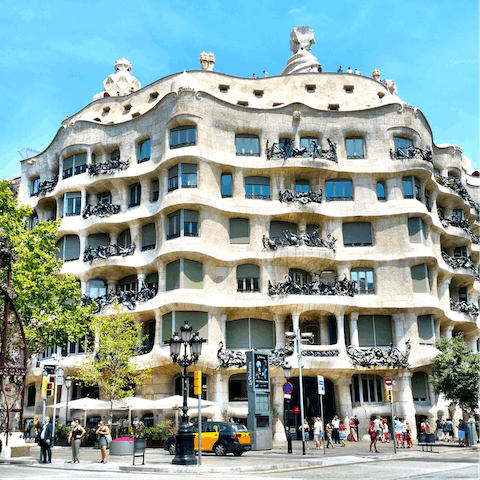 Visit Gaudí's magnificent Casa Milà, a twenty-five-minute walk away