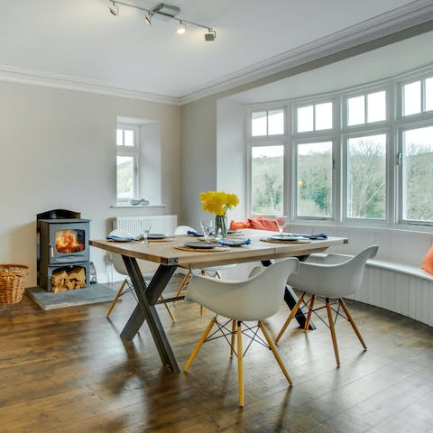 Gather around the dining table for heart-warming dinners at home, enjoying the view from the bay window