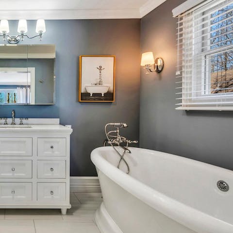 Take a well-earned soak in the elegant freestanding bathtub
