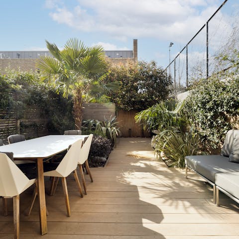 Soak up the sun out on the gorgeous decking, surrouded by plants
