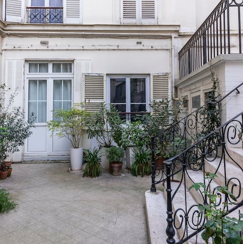 Stay in a quiet apartment overlooking a leafy courtyard