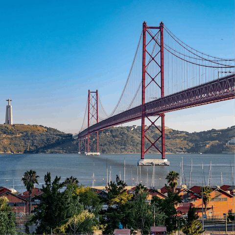 Rent an electric scooter and whizz along the riverfront to the 25 de Abril Bridge – it'll take around twenty minutes 