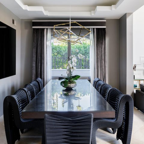 Serve a luxurious spread at the dining table with its work-of-art chairs